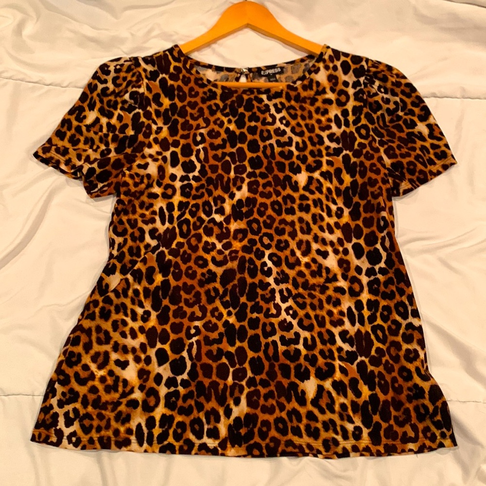 Express short sleeve dress shirt, ruffled shoulders and clasp back key hole.